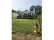 Side view of home with a hydrant in the yard at 76 Sumner Nw Ave, Concord, NC 28027