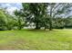 Exterior view of a home with a green lawn and mature trees creating a serene backdrop at 8334 Oaktree Rd, Sharon, SC 29742