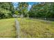 Exterior view of a home with a green lawn and mature trees creating a serene backdrop at 8334 Oaktree Rd, Sharon, SC 29742