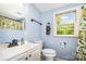 Fresh bathroom with blue walls, white fixtures, and a window offering natural light at 8334 Oaktree Rd, Sharon, SC 29742