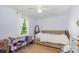 Bedroom with a large window, soft lighting, and a cozy daybed with modern decor at 8334 Oaktree Rd, Sharon, SC 29742