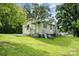 Exterior view of a cozy home with a green lawn and mature trees creating a serene backdrop at 8334 Oaktree Rd, Sharon, SC 29742
