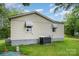 Exterior of a home with two small windows and an AC unit outside of the house at 8334 Oaktree Rd, Sharon, SC 29742