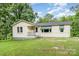 Charming single-story home with a welcoming front porch and lush green lawn at 8334 Oaktree Rd, Sharon, SC 29742