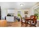 Eat-in kitchen features white cabinets, wood floor, and a dining table with four chairs at 8334 Oaktree Rd, Sharon, SC 29742