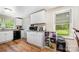 Functional kitchen with white cabinets, new appliances, and hardwood floor at 8334 Oaktree Rd, Sharon, SC 29742