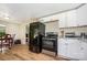 Kitchen and dining area with appliances, cabinetry, and hardwood floors at 8334 Oaktree Rd, Sharon, SC 29742