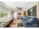 Open-concept living room with comfortable seating, large windows and lots of natural light at 8334 Oaktree Rd, Sharon, SC 29742