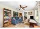 Comfortable living room featuring a plush sofa, bookshelves, and natural light at 8334 Oaktree Rd, Sharon, SC 29742
