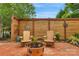 Charming brick patio with Adirondack chairs, metal art, and a fire pit, creating a cozy outdoor retreat at 8725 Soaring Eagle Ln, Waxhaw, NC 28173