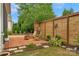 Relaxing back patio with brick pavers, wooden chairs, and a fire pit, perfect for outdoor entertaining and relaxation at 8725 Soaring Eagle Ln, Waxhaw, NC 28173