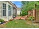 Landscaped backyard featuring a small patio and lawn area at 8725 Soaring Eagle Ln, Waxhaw, NC 28173