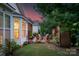 Inviting backyard with brick patio, wooden chairs around the fire pit, and mature trees at 8725 Soaring Eagle Ln, Waxhaw, NC 28173