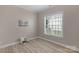 Neutral bedroom with natural light from a window and light wood flooring at 8725 Soaring Eagle Ln, Waxhaw, NC 28173
