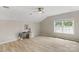 Light-filled bedroom with a vaulted ceiling, neutral walls, and wood flooring at 8725 Soaring Eagle Ln, Waxhaw, NC 28173
