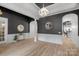 Open dining room with hardwood floors, decorative mirror, and pendant lighting at 8725 Soaring Eagle Ln, Waxhaw, NC 28173