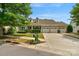 Charming brick-front home with three-car garage, dormer windows, and manicured lawn at 8725 Soaring Eagle Ln, Waxhaw, NC 28173