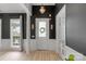 Elegant foyer with wainscoting, decorative lighting, and glass-paneled doors at 8725 Soaring Eagle Ln, Waxhaw, NC 28173