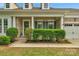 Inviting brick home with a covered porch, manicured landscaping, and an attached garage, exuding curb appeal at 8725 Soaring Eagle Ln, Waxhaw, NC 28173