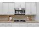 Close-up of kitchen with stainless steel microwave, gas range, and granite countertops at 8725 Soaring Eagle Ln, Waxhaw, NC 28173