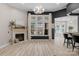 Bright living room with fireplace, large window, wood flooring and elegant light fixture at 8725 Soaring Eagle Ln, Waxhaw, NC 28173