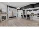 Open living area with fireplace, large windows, breakfast bar, and white kitchen cabinets at 8725 Soaring Eagle Ln, Waxhaw, NC 28173