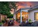 Relaxing brick patio with outdoor seating, screened porch, and lush landscaping at 8725 Soaring Eagle Ln, Waxhaw, NC 28173