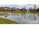A serene pond reflects the community's amenities on a beautiful day at 8725 Soaring Eagle Ln, Waxhaw, NC 28173