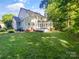 The backyard features ample green space and large windows for natural light at 8803 Sweetwater Pl, Waxhaw, NC 28173