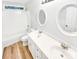Bathroom featuring wood look flooring, double vanity and tub and shower combo at 8803 Sweetwater Pl, Waxhaw, NC 28173