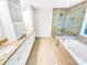 Modern bathroom with a glass-enclosed shower, soaking tub, and dual vanities at 8803 Sweetwater Pl, Waxhaw, NC 28173