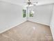 Bright bedroom featuring neutral carpet and natural light from the room's two windows at 8803 Sweetwater Pl, Waxhaw, NC 28173