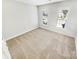 Bright bedroom featuring neutral carpet and large windows at 8803 Sweetwater Pl, Waxhaw, NC 28173