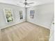 Bright bedroom with neutral carpet, ceiling fan, and multiple windows offering ample natural light at 8803 Sweetwater Pl, Waxhaw, NC 28173