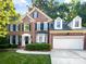 Charming two-story brick home featuring a manicured lawn and mature trees at 8803 Sweetwater Pl, Waxhaw, NC 28173