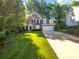 Charming two-story brick home featuring a well-manicured lawn and mature trees at 8803 Sweetwater Pl, Waxhaw, NC 28173