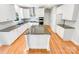 Modern kitchen featuring a central island, stainless appliances, and hardwood floors at 8803 Sweetwater Pl, Waxhaw, NC 28173