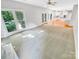 Bright living room with carpet and large windows featuring a pass through into the eat-in kitchen at 8803 Sweetwater Pl, Waxhaw, NC 28173