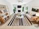 Bright, staged living room with fireplace, neutral decor, and ample natural light at 8803 Sweetwater Pl, Waxhaw, NC 28173