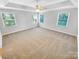 Spacious main bedroom featuring neutral carpet, large windows and a ceiling fan at 8803 Sweetwater Pl, Waxhaw, NC 28173