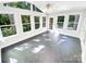 Bright sun room surrounded by windows featuring ceramic tile floors and a ceiling fan at 8803 Sweetwater Pl, Waxhaw, NC 28173