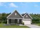 Charming single-Gathering home featuring stone accents, a covered porch, and a well-manicured front yard at 897 Exeter Dr, Sherrills Ford, NC 28673