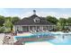 Community pool with lounge chairs, tables, and clubhouse in background at 897 Exeter Dr, Sherrills Ford, NC 28673