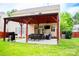 Enjoy this backyard and covered patio with outdoor kitchen and ample seating at 9805 Coatbridge Dr, Charlotte, NC 28269