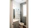 Cozy half bath with gray vanity, framed mirror, and artwork on display at 9805 Coatbridge Dr, Charlotte, NC 28269