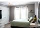 Comfortable bedroom with modern furnishings, soothing colors, and a large window for natural light at 9805 Coatbridge Dr, Charlotte, NC 28269