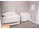 Charming Bedroom equipped with a crib and changing table, creating a snug and useful area for childcare at 9805 Coatbridge Dr, Charlotte, NC 28269