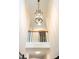 Bright entryway boasts a modern chandelier and white wainscoting to enhance the appealing design at 9805 Coatbridge Dr, Charlotte, NC 28269