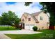 Well-maintained home with a lush green lawn and a spacious driveway leading to a two-car garage at 9805 Coatbridge Dr, Charlotte, NC 28269