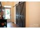 Entryway featuring sliding barn doors, wood flooring and access to natural light at 9805 Coatbridge Dr, Charlotte, NC 28269